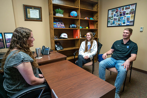 students with professor in office