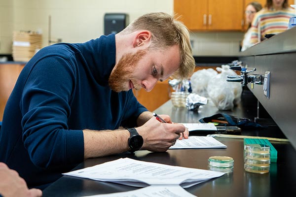 male student in science lab