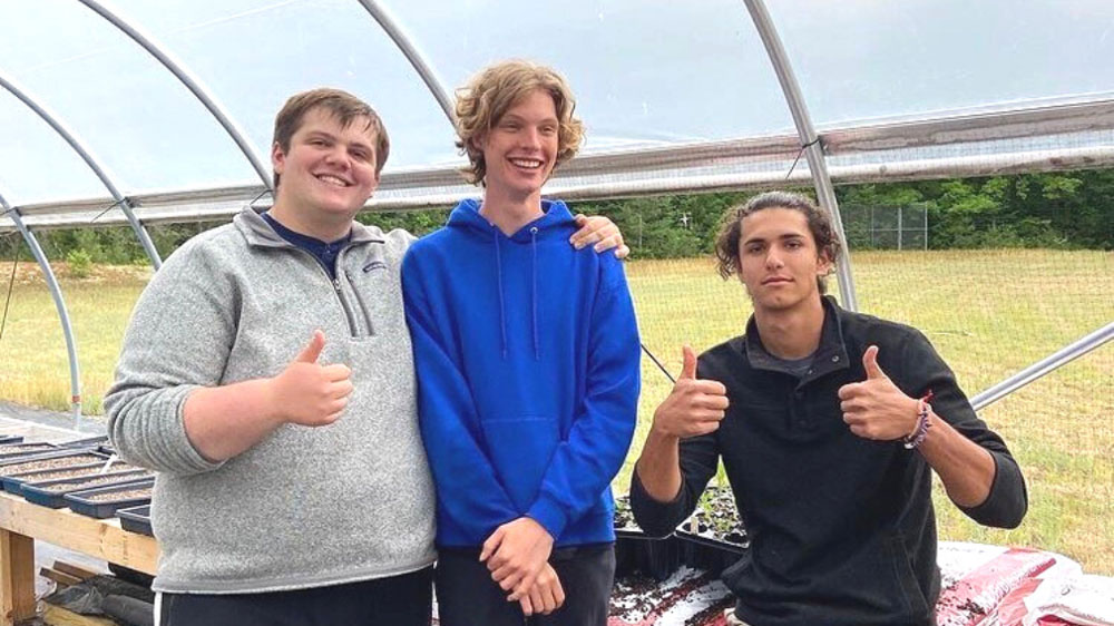 Sully Proctor '24 standing next to two other interns