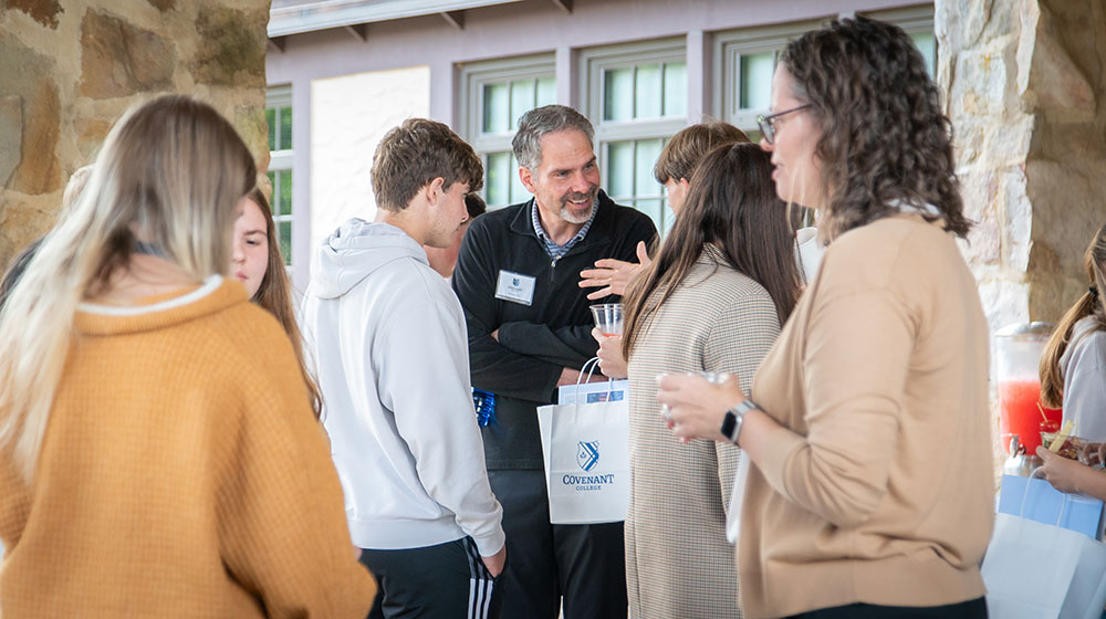 students, families, and faculty at a sneakpeak social