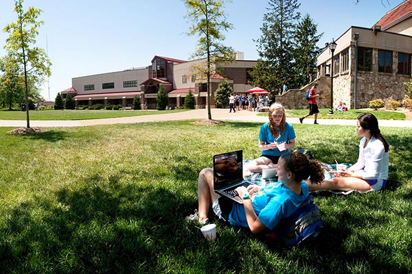 students on lawn in front of mills hall