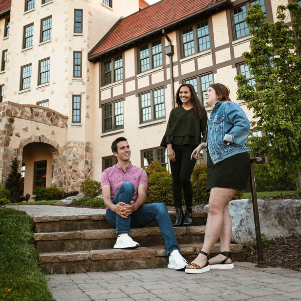 students talking on steps in front of carter hall